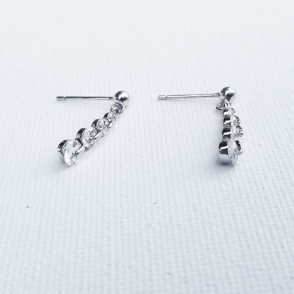 Sparkle your way to the top with the gorgeous Linear Drop Cubic Zirconia Earrings. The chain, crafted in 925 Sterling Silver and plated in White Gold showcasing 5 Cubic Zirconia is the perfect touch of glow  and elegance. Perfect for special occasions or everyday styling to show your amazing confidence and glam.